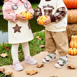 Children wearing pink and green EBMINI AERO baby sneakers outdoors