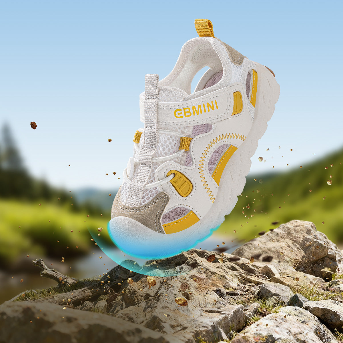 Yellow EBMINI APEX sport sandal in an outdoor rock scene