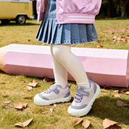 Child wearing purple EBMINI BREEZE wide-toe sneakers at the park