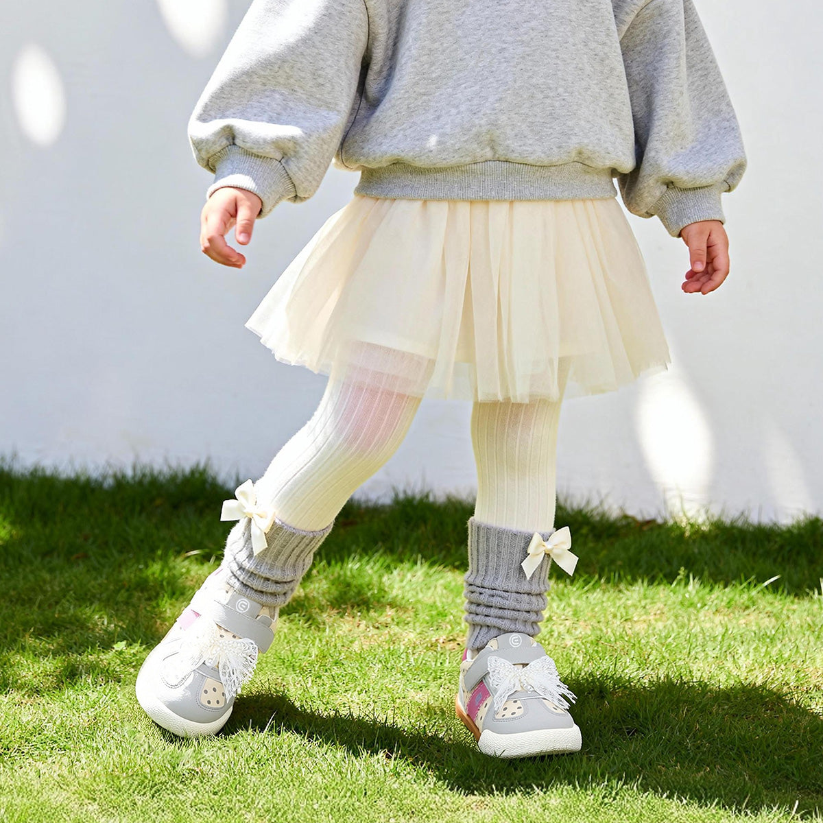 Child wearing Grey EBMINI DOTE toddler sneakers outdoors