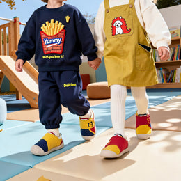 Toddler taking first steps in EBMINI PICO barefoot sneakers
