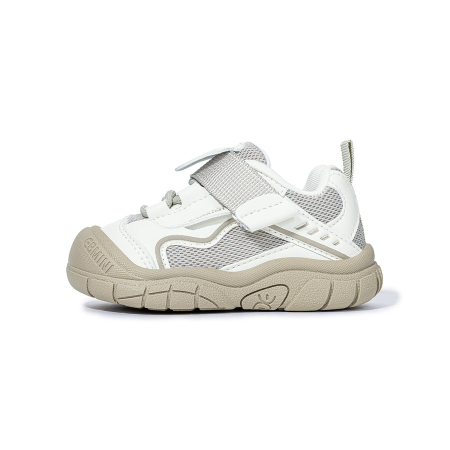 Side view of white EBMINI SHIELD wide-toe sneaker with protective bumper