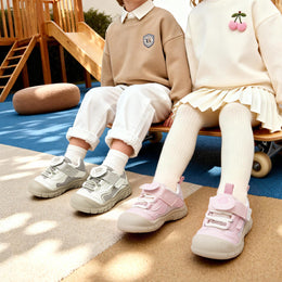 Children wearing EBMINI SHIELD white and pink sneakers at the playground