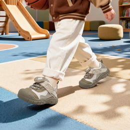 Child walking in brown EBMINI SHIELD protective toddler sneakers